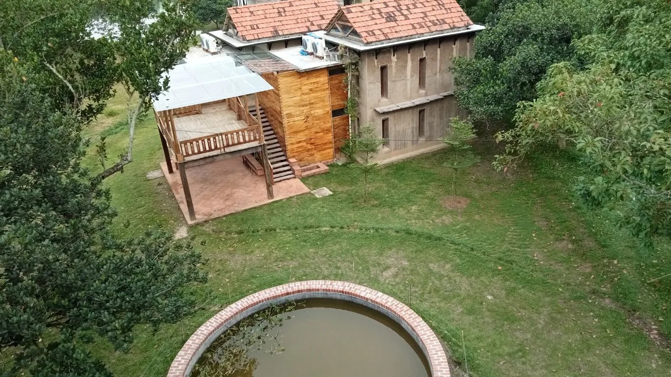 Aerial view of a mud house and pool at the resort in Sreepur, Gazipur