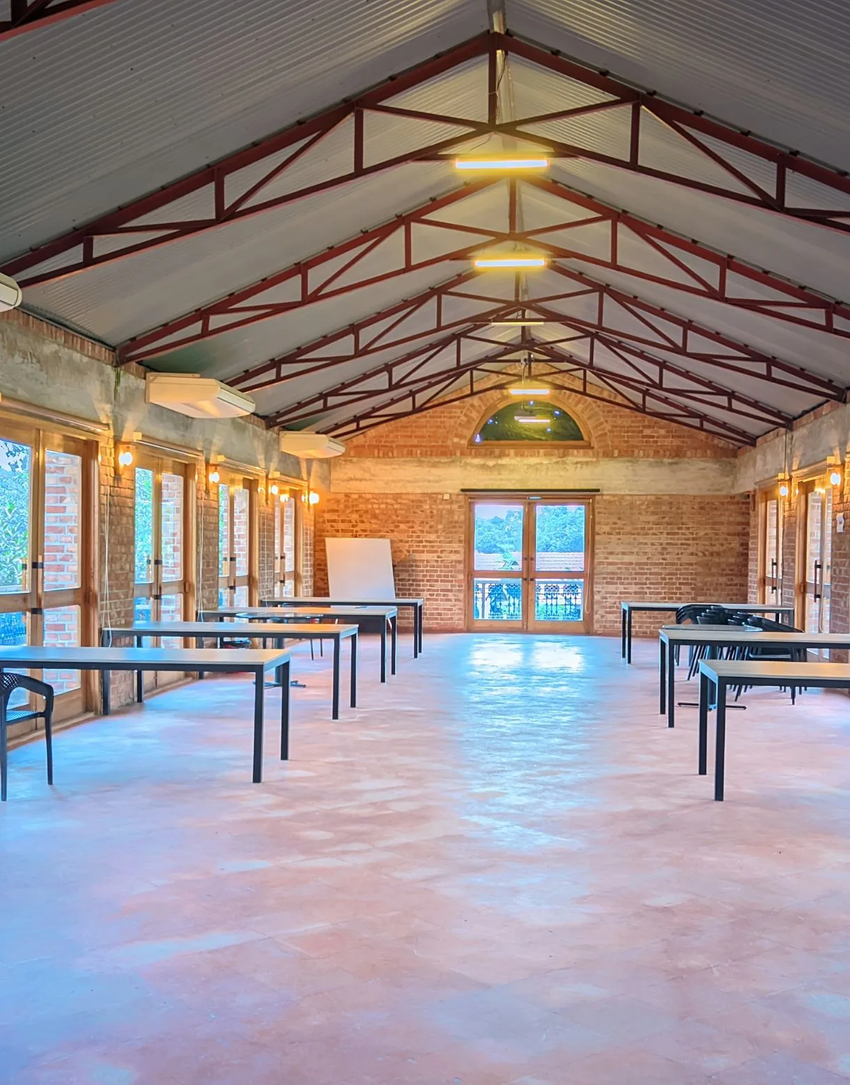Eco conference hall with brick walls and timber roof trusses at the resort