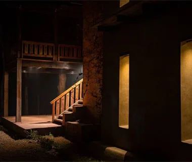 Timber veranda and staircase of a mud house at the resort