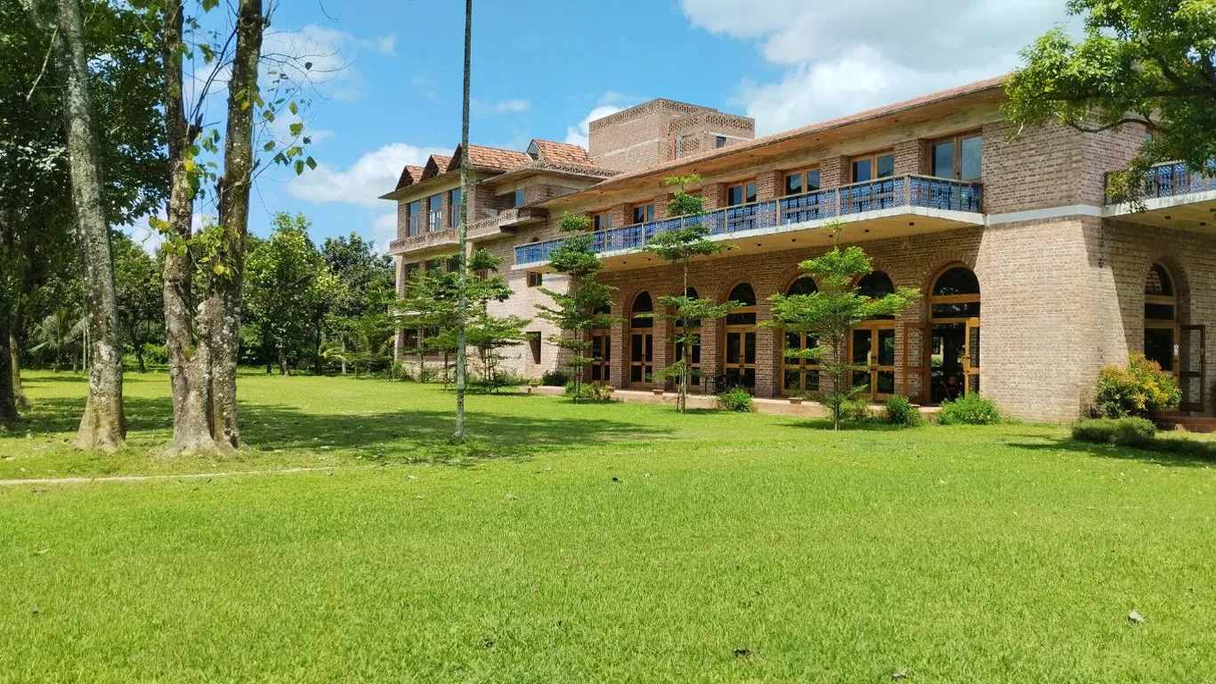 Mud house villas and lawn at Matir Maya Eco Resort in Sreepur, Gazipur