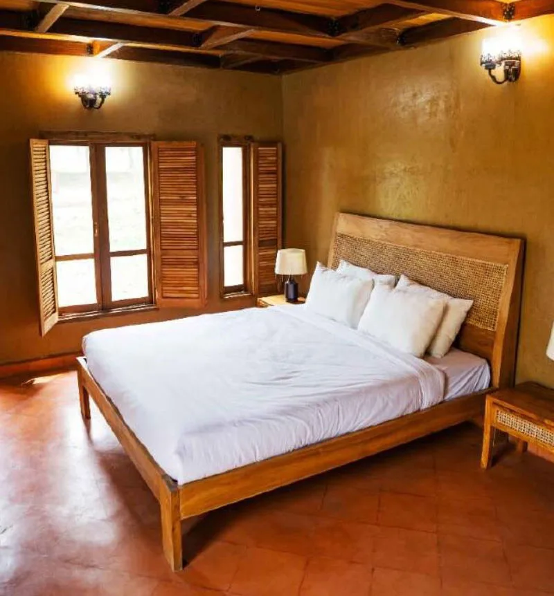Standard room with king bed and mud walls at Matir Maya Eco Resort, Sreepur, Gazipur