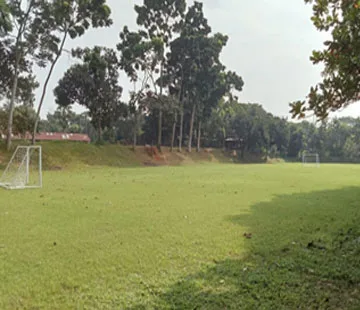 Open playground field with goalpost at the eco resort in Sreepur