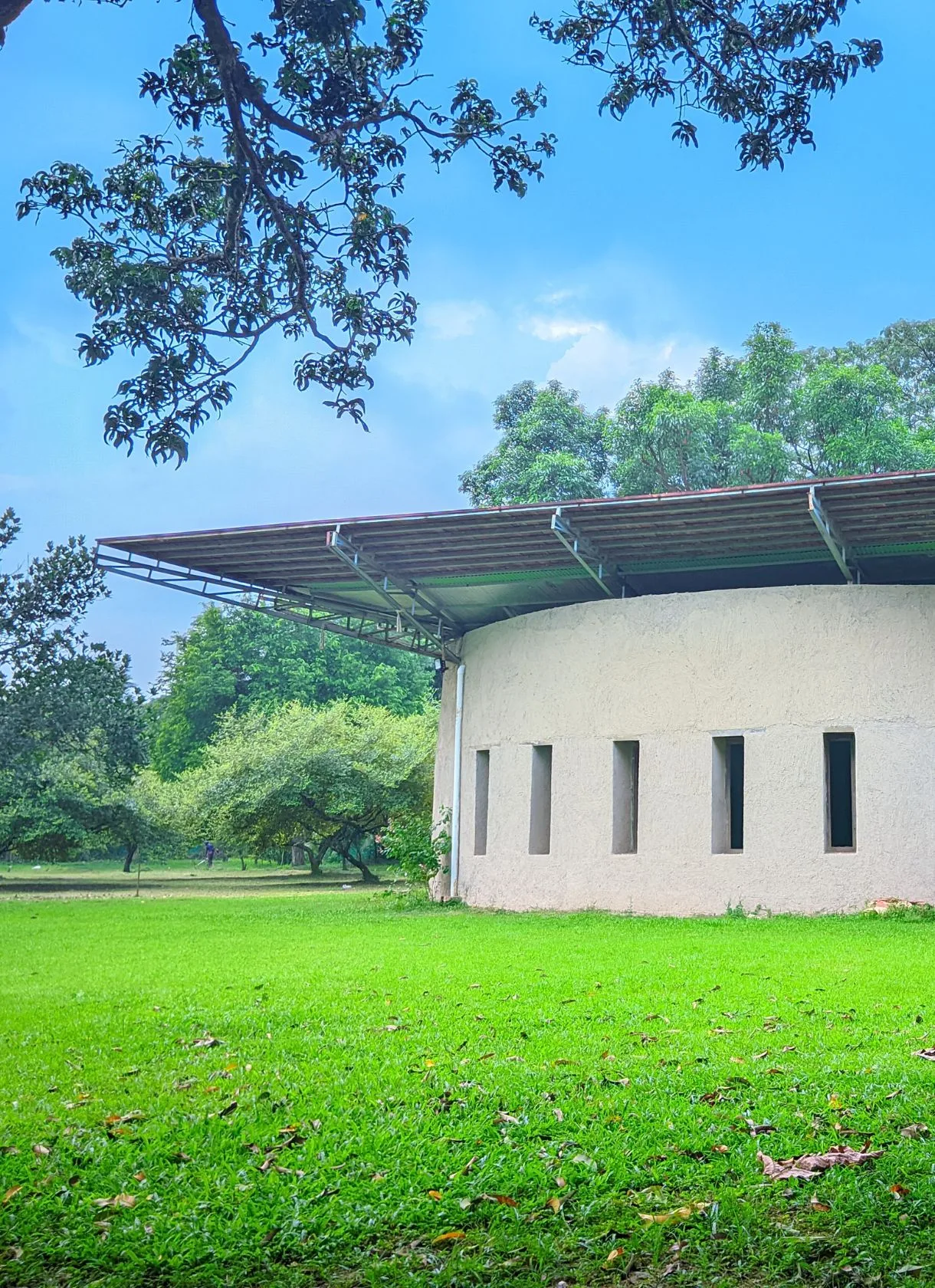 Curved white conference building on the lawn at the eco resort